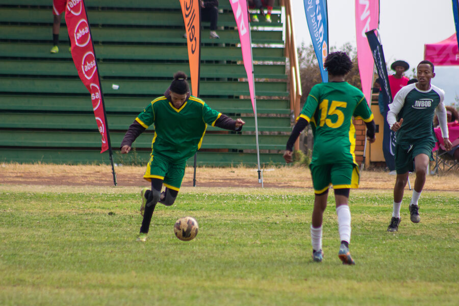 Players in green kit press forward
