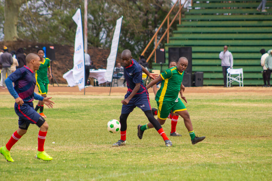 Navy and green teams contest the ball