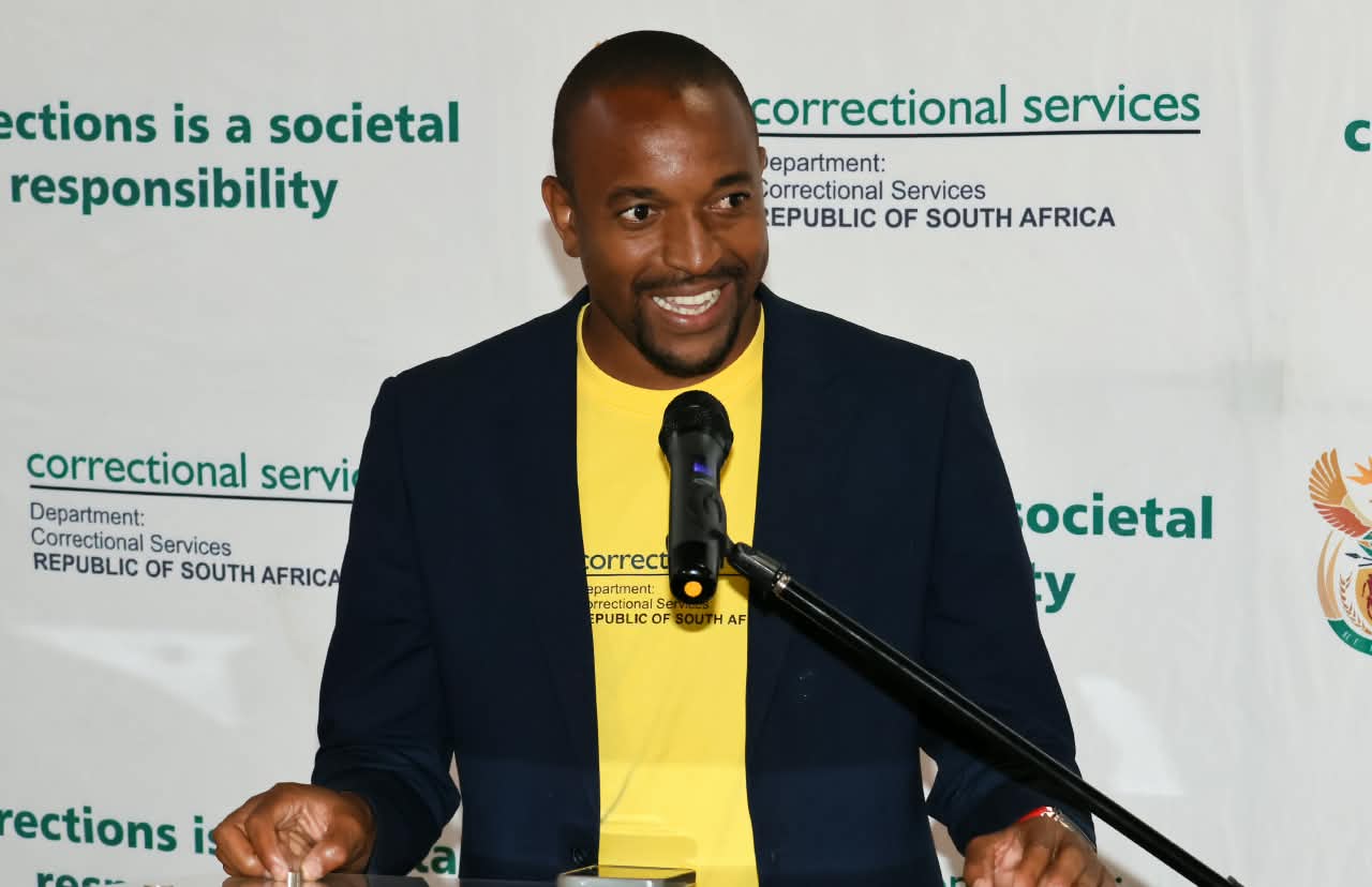 Tiyani Mabunda speaking at a podium at a Department of Correctional Services event